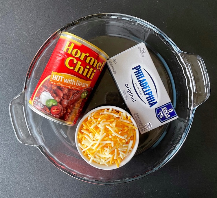 If you're throwing a party and looking for easy appetizers to feed a crowd, you've got to try this 3 ingredient chili cheese dip! It's quick to make with just cream cheese, a can of chili and shredded cheese. Serve warm with tortilla chips! My favorite cheap snack for parties. 