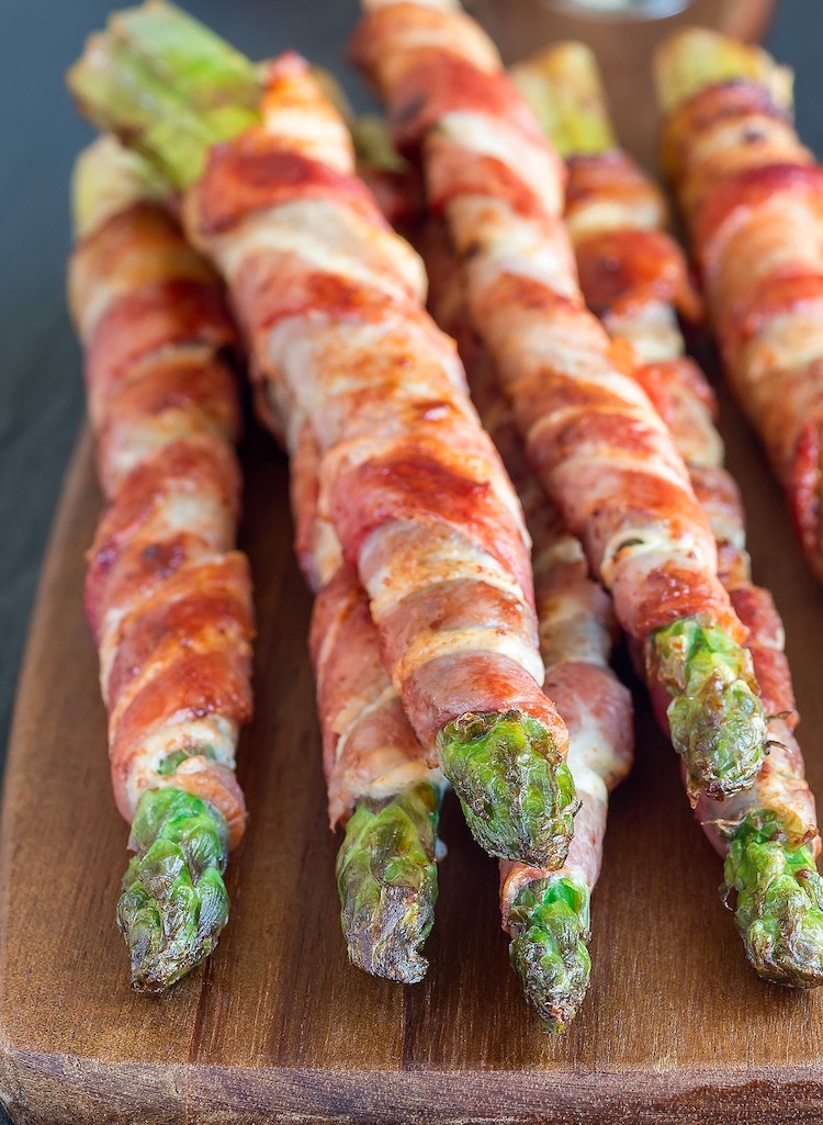 Close up of asparagus wrapped in crispy bacon, an amazing side dish for any meal including steak, chicken, bbq, and seafood. 
