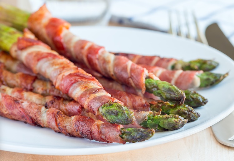 How to make bacon wrapped asparagus in the oven at 400° F. An easy and impressive side dish for just about any meal. 